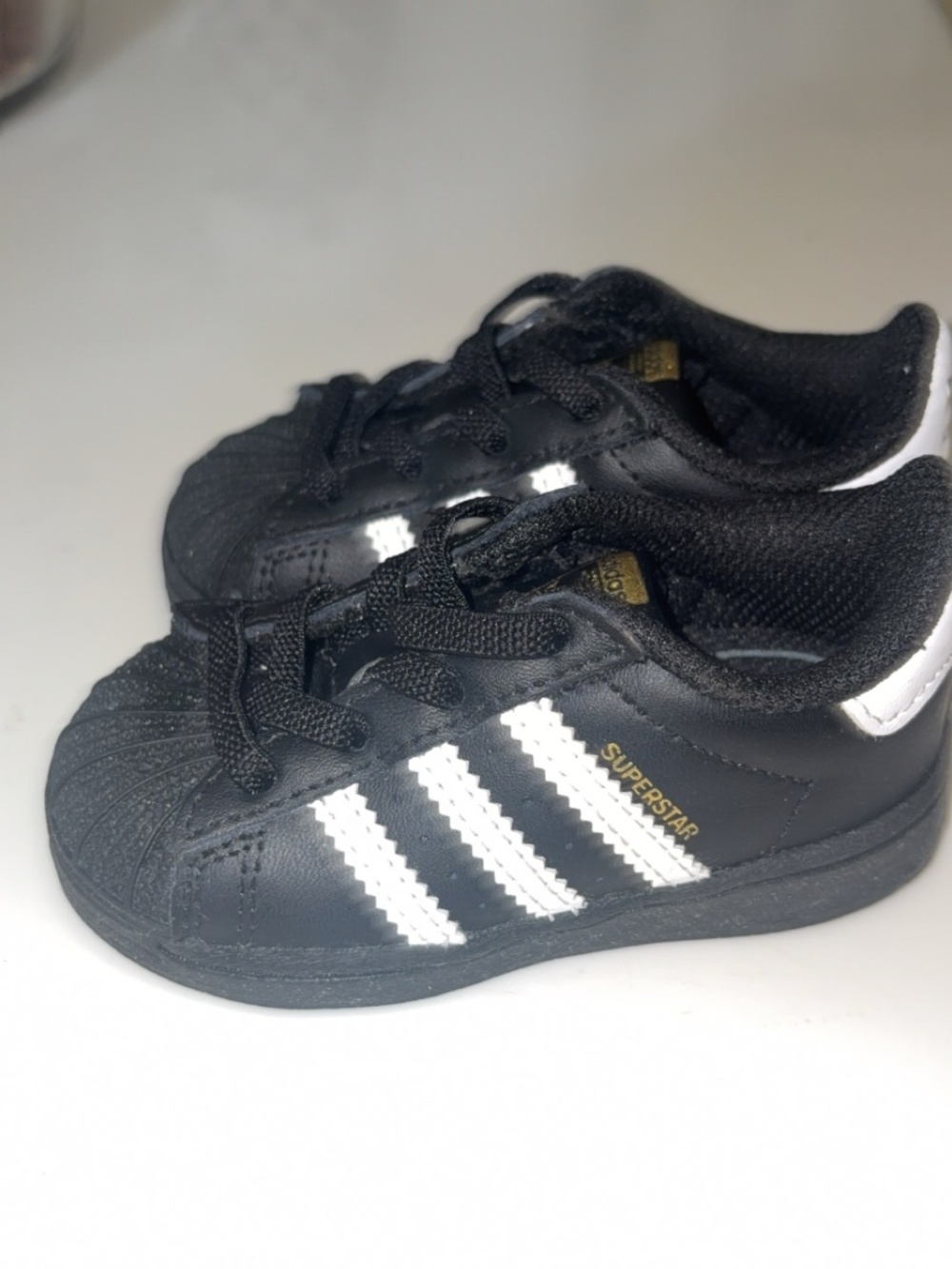 Adidas Superstar toddler sneakers.